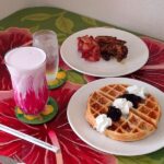 Hibiscus Cafe Oistins Barbados Breakfast Spread with Mouth Watering waffles with cream, berries and crispy bacon