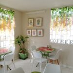 Hibiscus Cafe Oistins Barbados Interior View Showing a quiet tropical oasis with hand painted tables and art